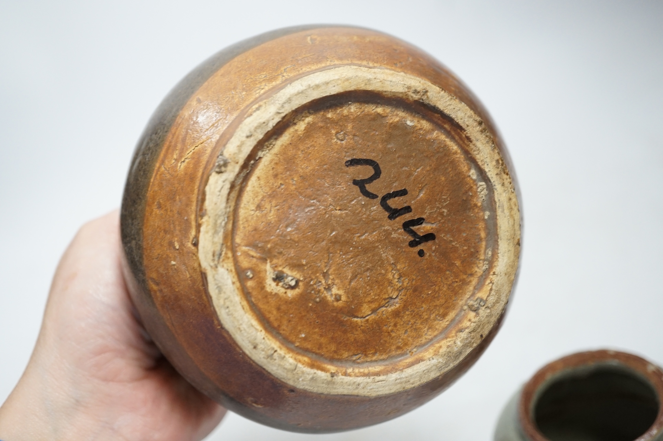 A Chinese brown partially glazed jar and a celadon jar, Song Dynasty largest 13cm in diameter